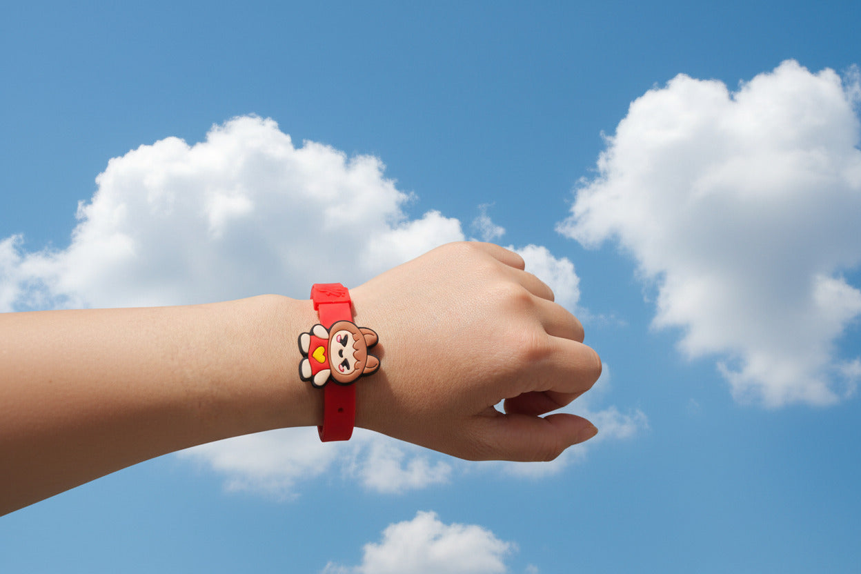 Hand wearing a red bracelet with a cartoon character with hand in a fist against a backdrop of a sunny sky and clouds.